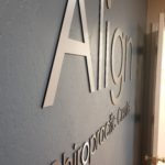 Brushed aluminum routed interior signage